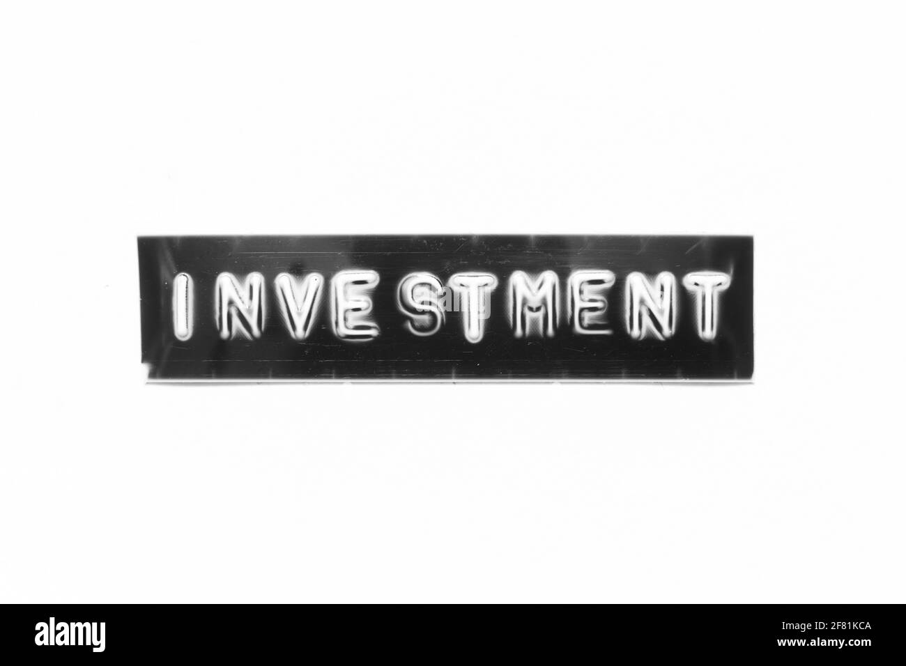 Embossed letter with word investment in black banner on white paper background Stock Photo
