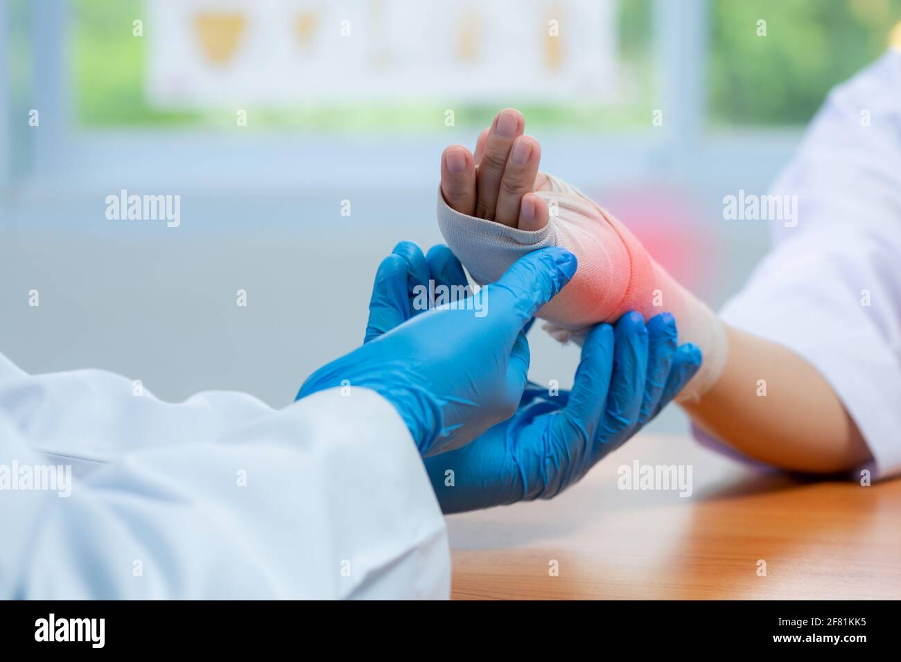 Orthopedic doctor wear medical gloves Of Doctor Hand Tying Bandage On