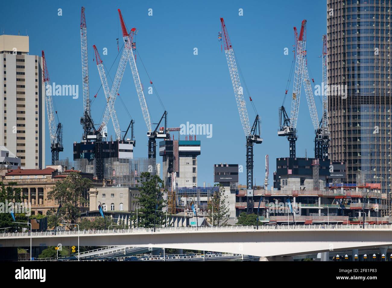 Cranes reach into the sky as construction under way in the heart of Brisbane. April 2021 Stock Photo