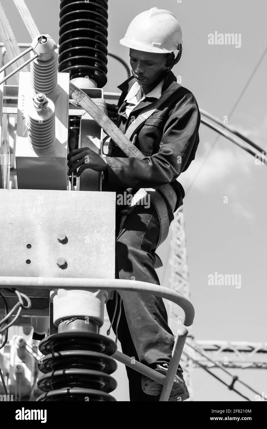 JOHANNESBURG, SOUTH AFRICA - Mar 13, 2021: Johannesburg, South Africa, 04/11/2012, Electricians working on high voltage power lines. Highly skilled wo Stock Photo