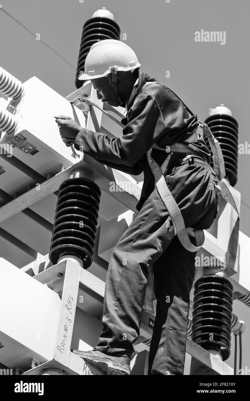 JOHANNESBURG, SOUTH AFRICA - Mar 13, 2021: Johannesburg, South Africa, 04/11/2012, Electricians working on high voltage power lines. Highly skilled wo Stock Photo