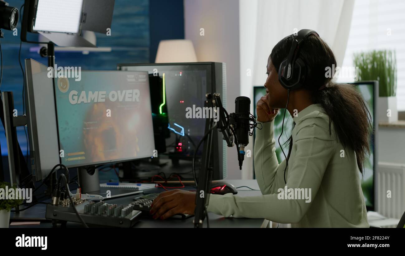 Back shot of pro gamer playing online shooter game on computer using  wireless controller. Competitive player man winning videogame tournament  use professional equipment at home gamming studio Stock Photo - Alamy