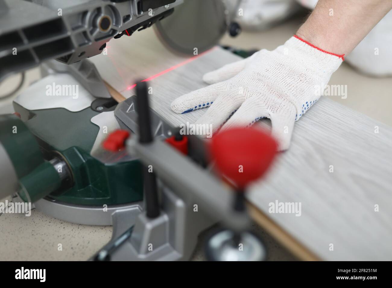 Builder cuts laminate board with circular saw Stock Photo Alamy