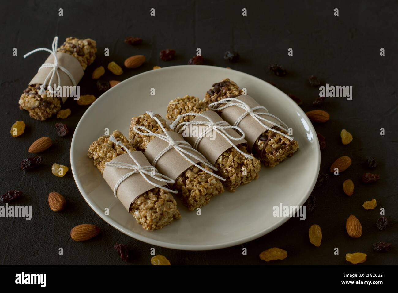 homemade granola energy bars with almond and raisins on black background. Healthy food. Stock Photo