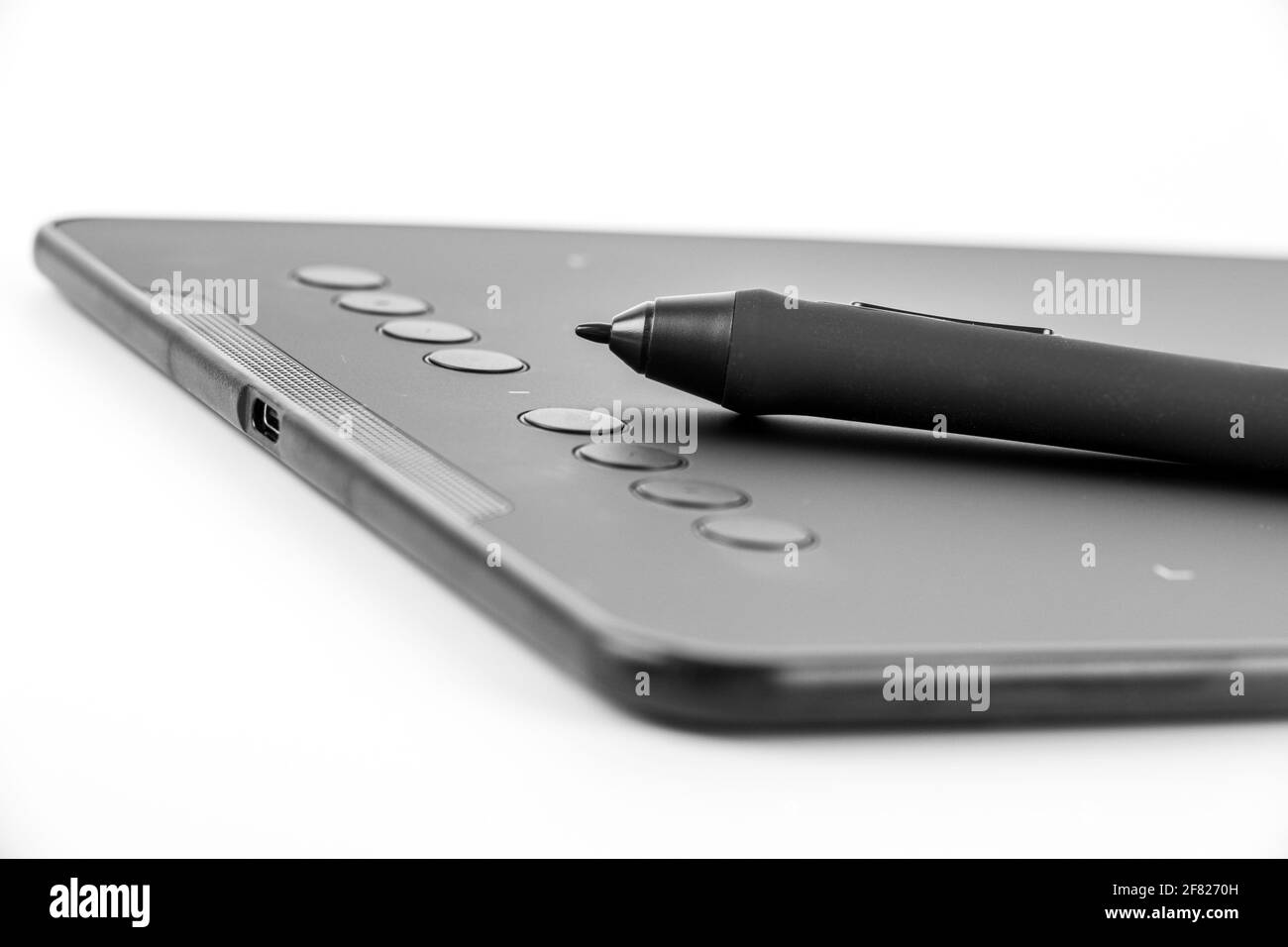 Black graphic tablet with pen for illustrators, designers and photographers, isolated on white background. Stock Photo