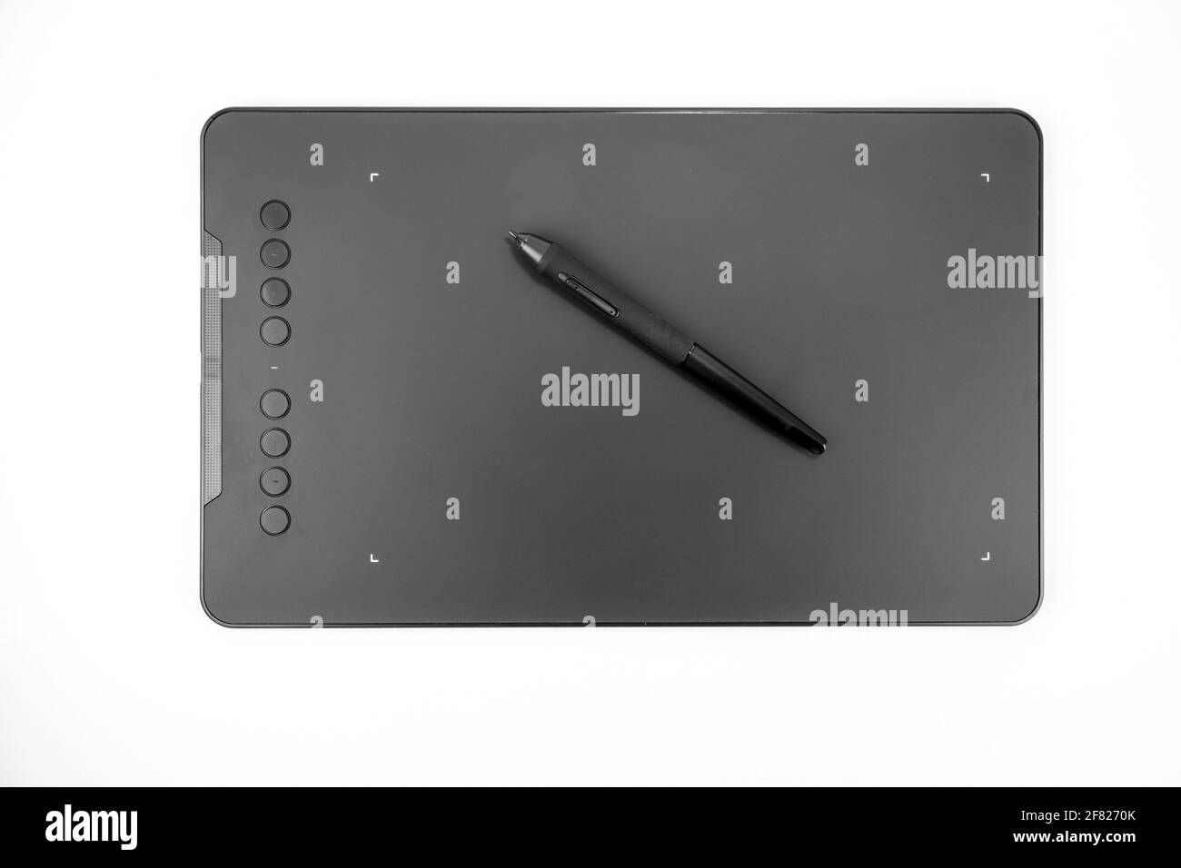 Black graphic tablet with pen for illustrators, designers and photographers, isolated on white background. Stock Photo