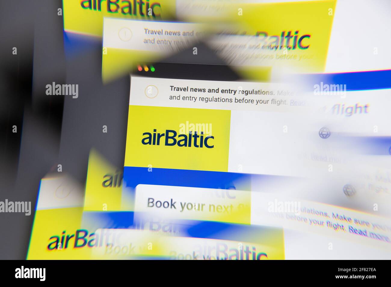 Milan, Italy - APRIL 10, 2021: airBaltic logo on laptop screen seen through an optical prism. Dynamic and unique image from airBaltic website. Illustr Stock Photo