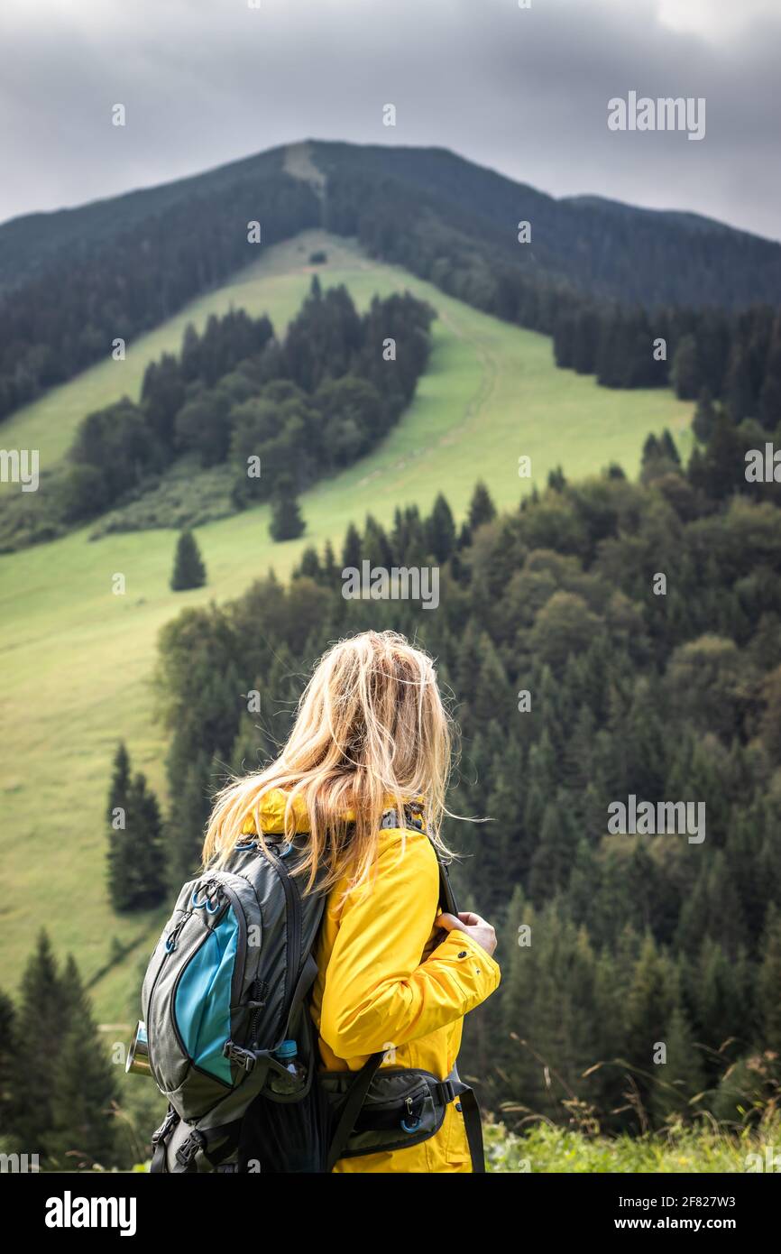 Woman hiking in mountain. Big sport challenge for hike. Long way up to hill. Female tourist in natural park Mala Ftara, Slovakia Stock Photo