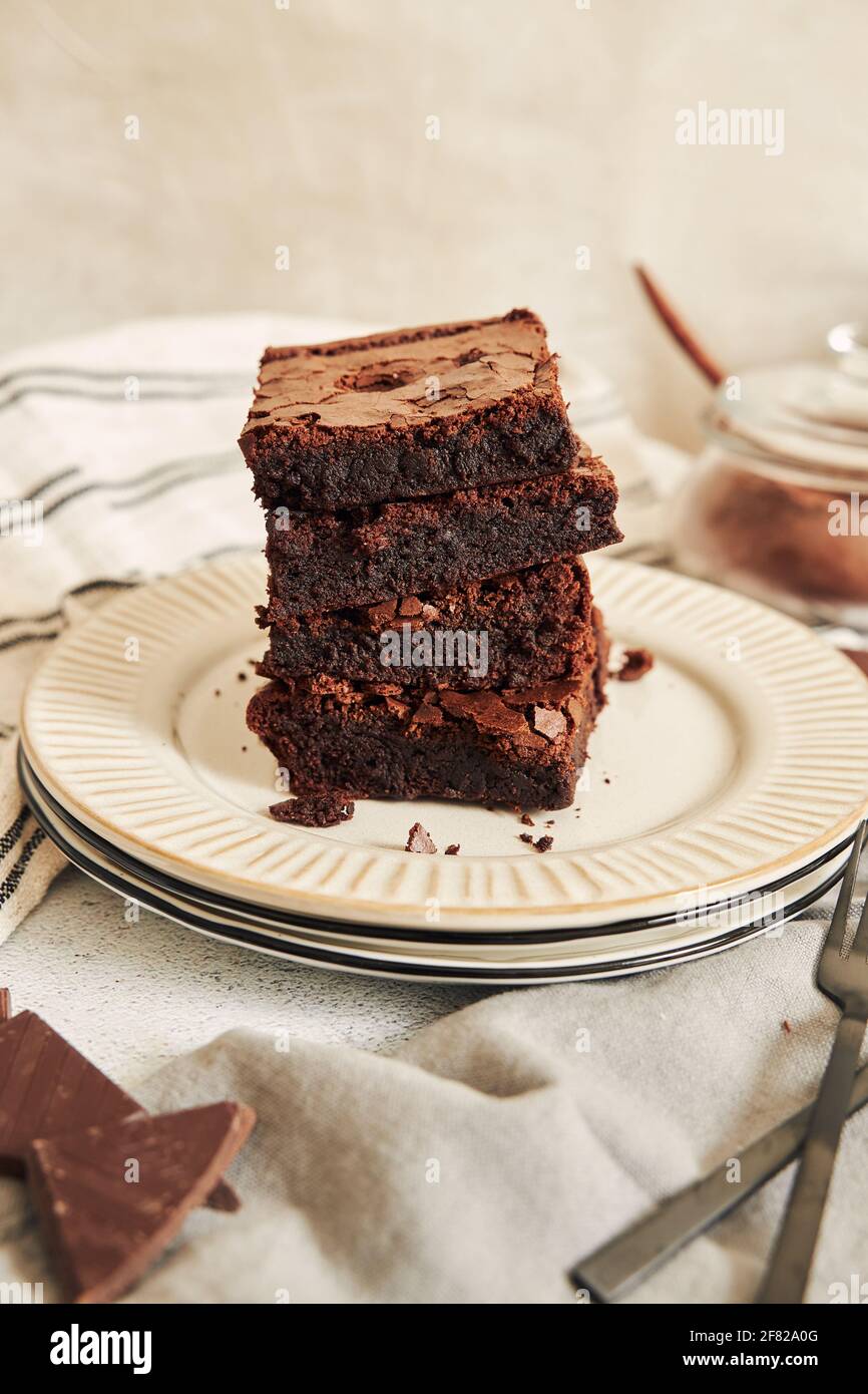 A vertical shot of delicious brownies on a white plate Stock Photo - Alamy