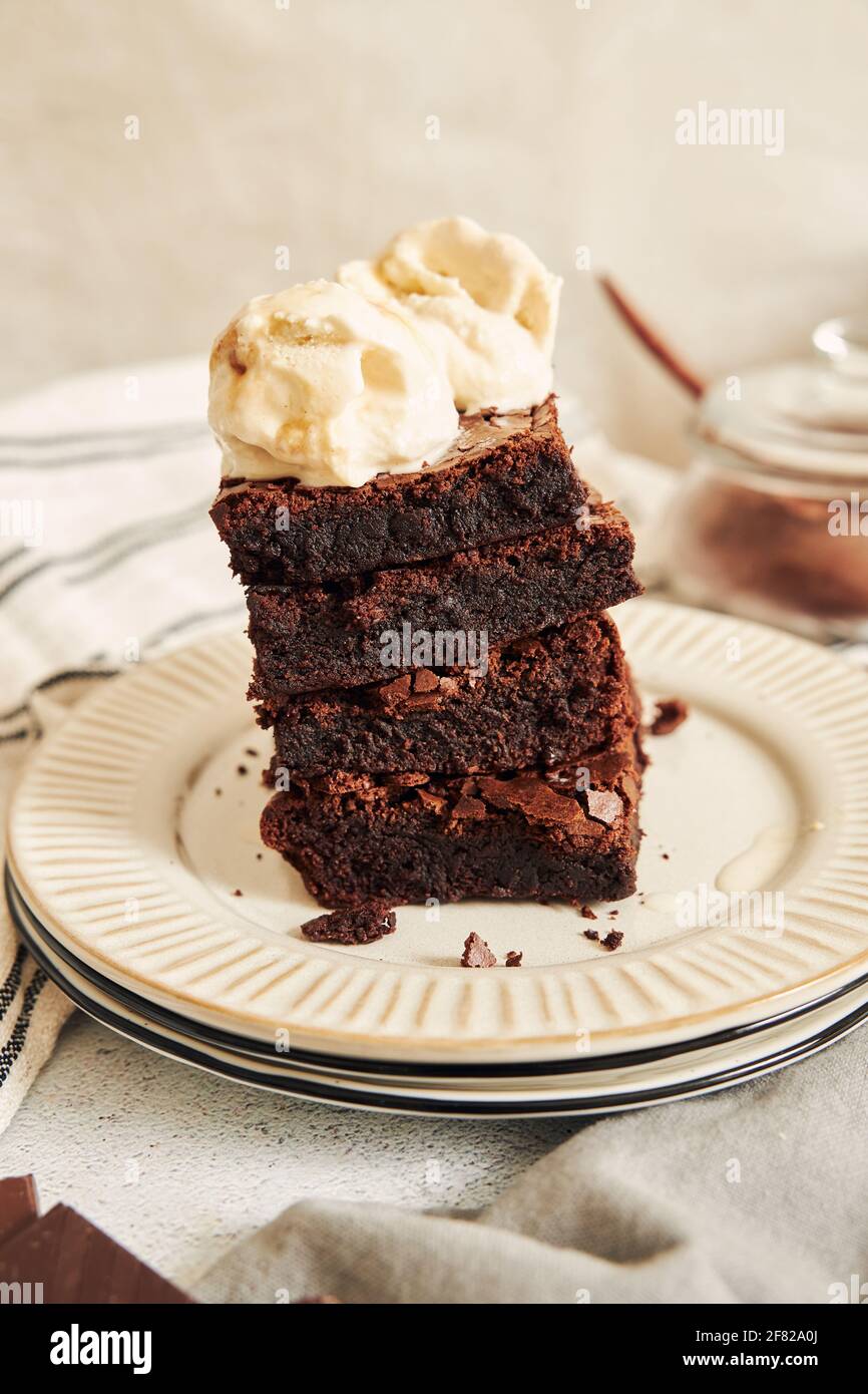 A vertical shot of delicious Brownies with Ice cream on top Stock Photo ...