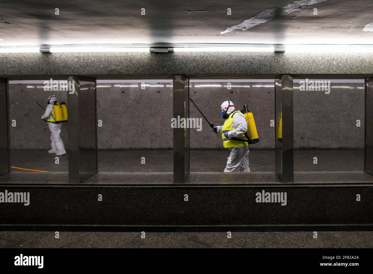 Cleaning service workers are seen disinfecting one of the most