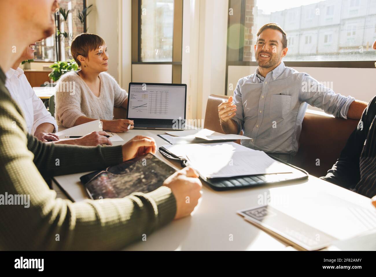 Man giving suggestions in business meeting. Male executive speaking in team meeting. Stock Photo
