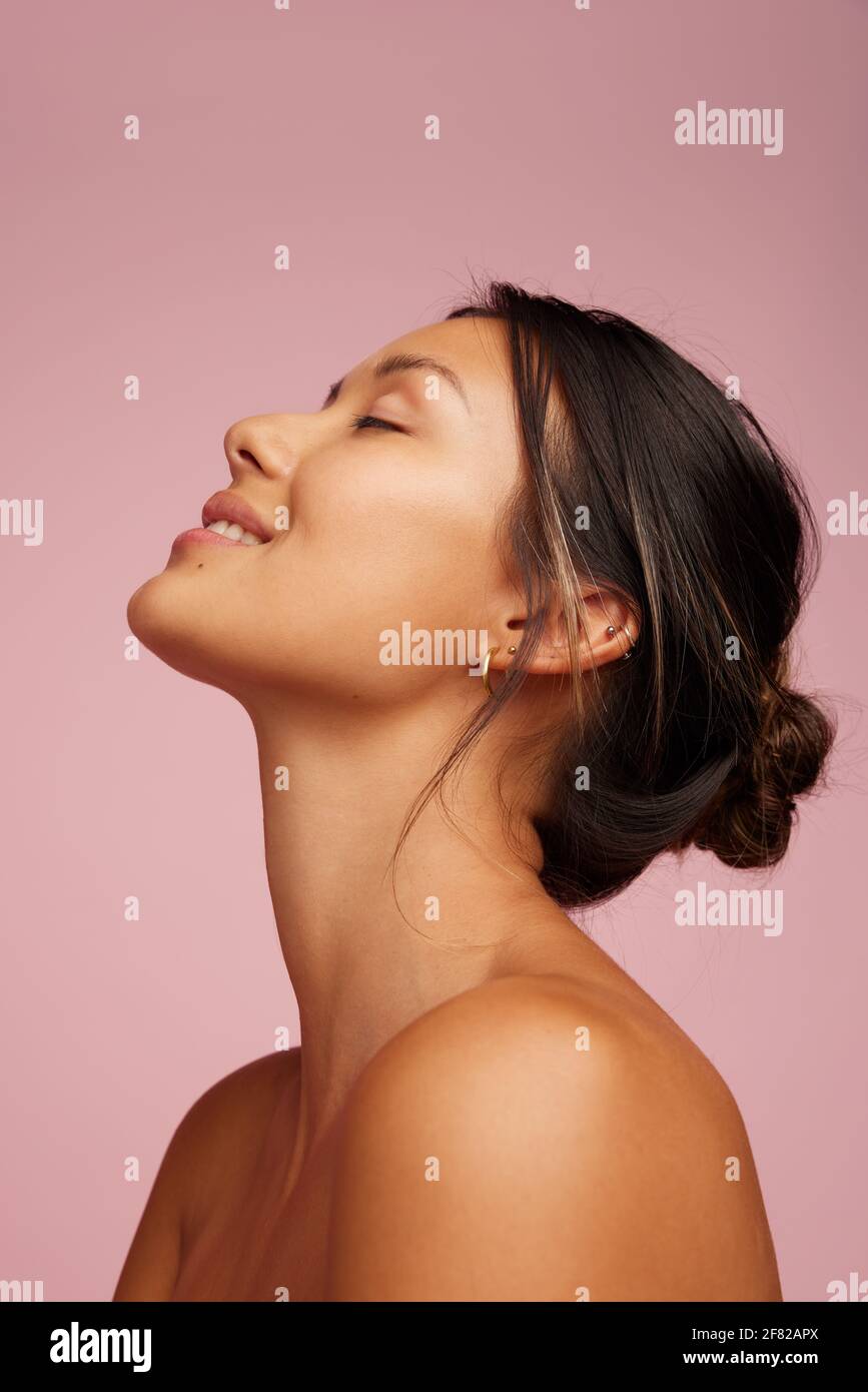 Closeup of a happy young woman with healthy skin. Female model with ...