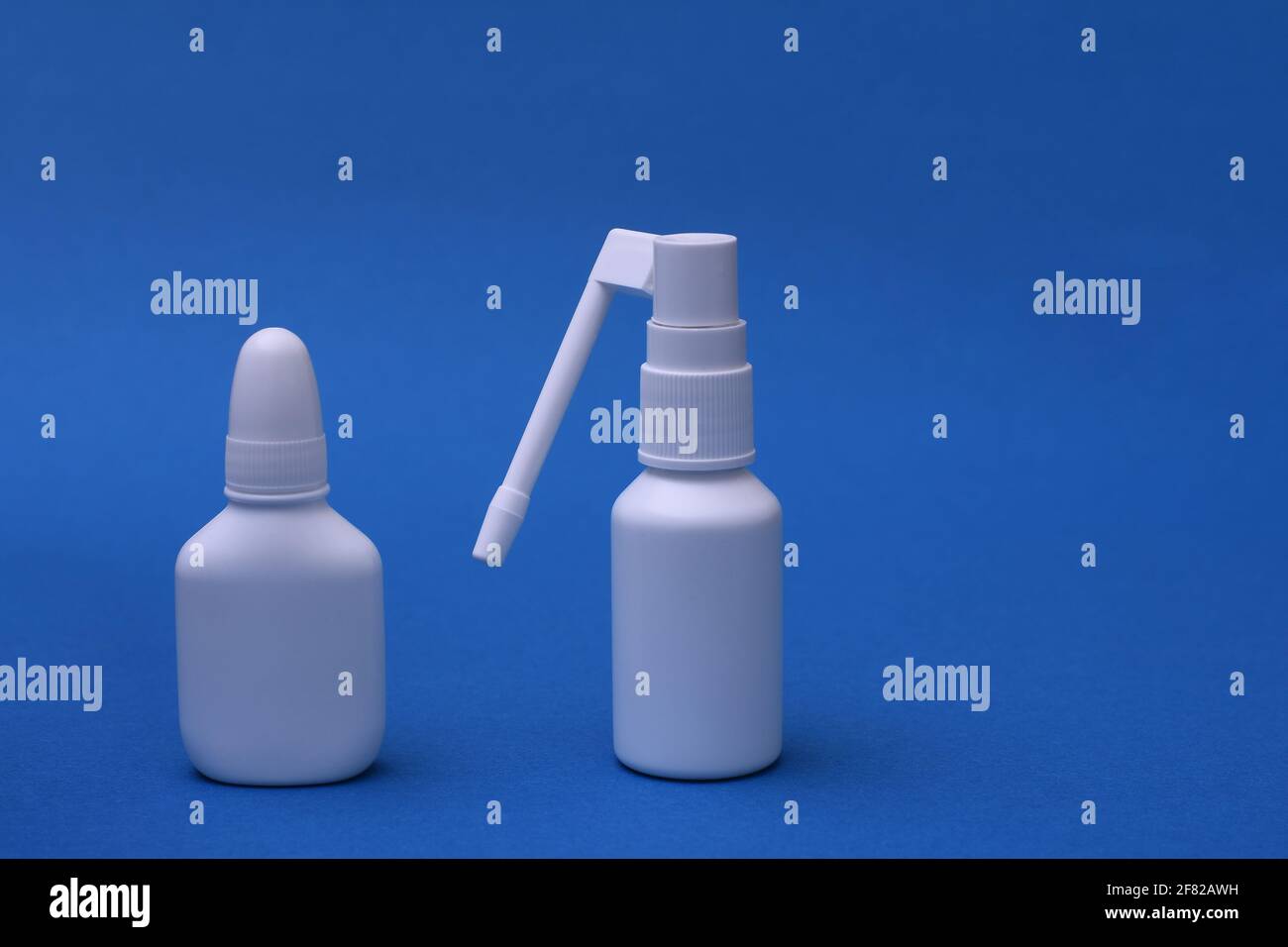 Nasal spray and throat spray on a blue background. space for writing Stock Photo