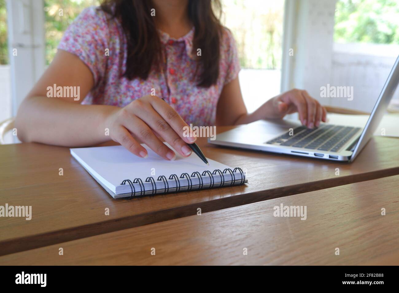 Female remotely working, studying online. Stock Photo