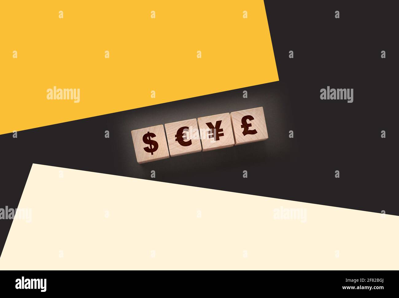 Dillar, euro, yen and pound on building blocks. wooden cubes with