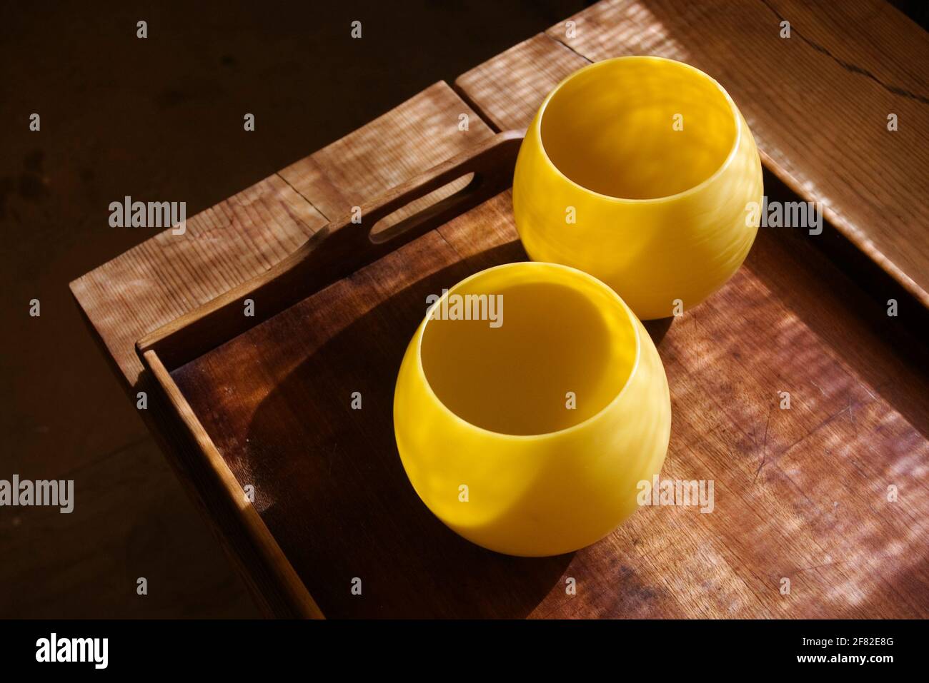 Bright yellow beeswax candle on wooden background Stock Photo