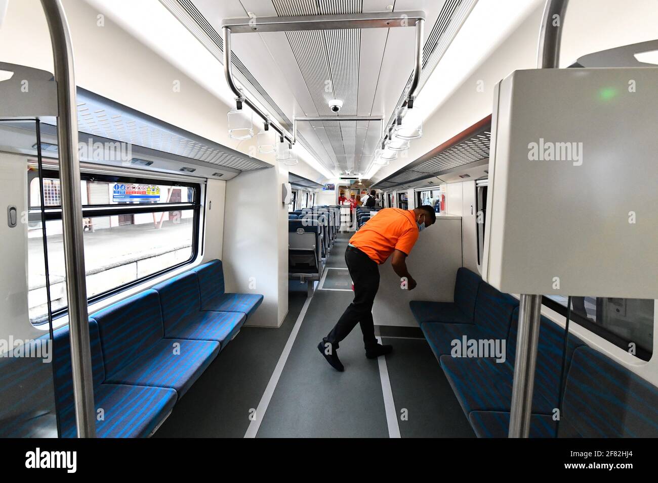 Kota Bharu, Malaysia's northern Kelantan state. 11th Apr, 2021. A worker cleans seats on the Diesel Multiple Unit train in Kota Bharu, the capital of Malaysia's northern Kelantan state, April 11, 2021. The Diesel Multiple Unit (DMU) trains manufactured by China Railway Rolling Stock Corporation (CRRC) Zhuzhou Electric Locomotive Co., Ltd were launched into operations on Sunday, which will boost connectivity and facilitate travel in Malaysia's eastern coast area. Credit: Zhu Wei/Xinhua/Alamy Live News Stock Photo