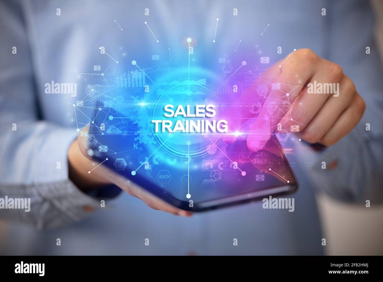 Businessman holding a foldable smartphone, new business concept Stock Photo