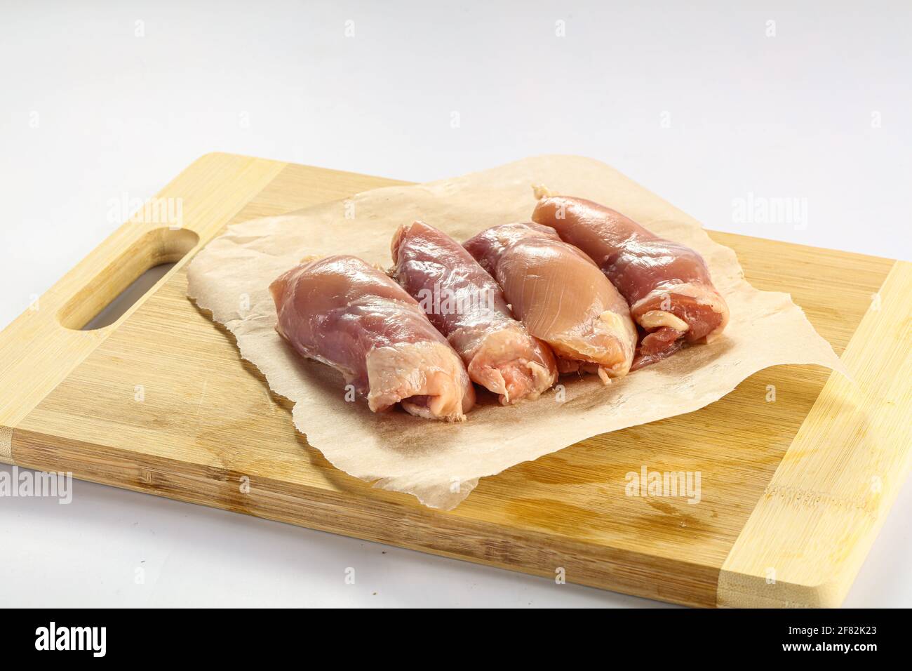 Raw chicken leg fillet over board isolated Stock Photo Alamy