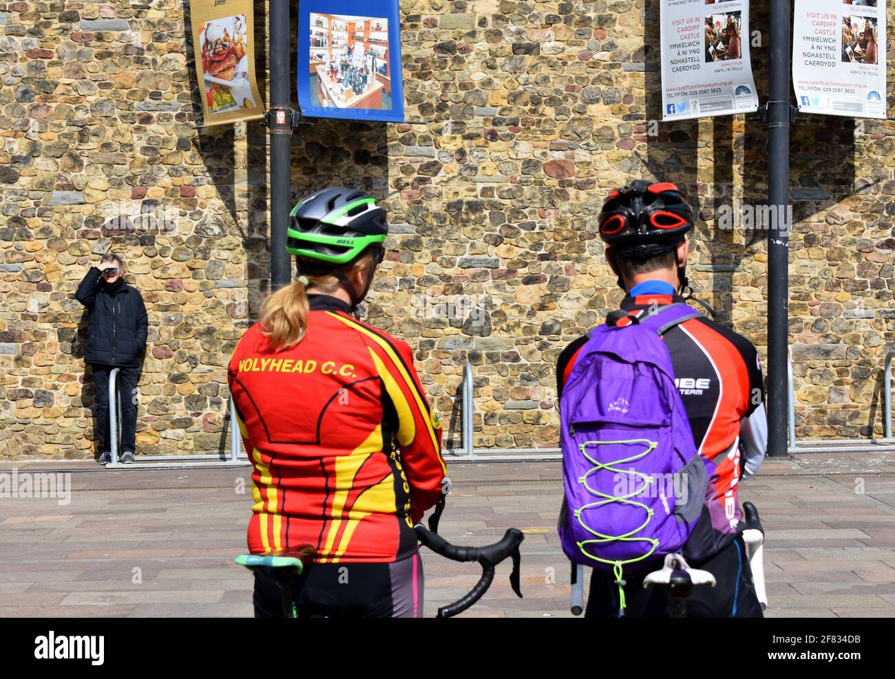 Pair of cyclists waiting outside Cardiff Castle for the 41 gun salute to mark Prince Philip's death, Cardiff, Wales Stock Photo