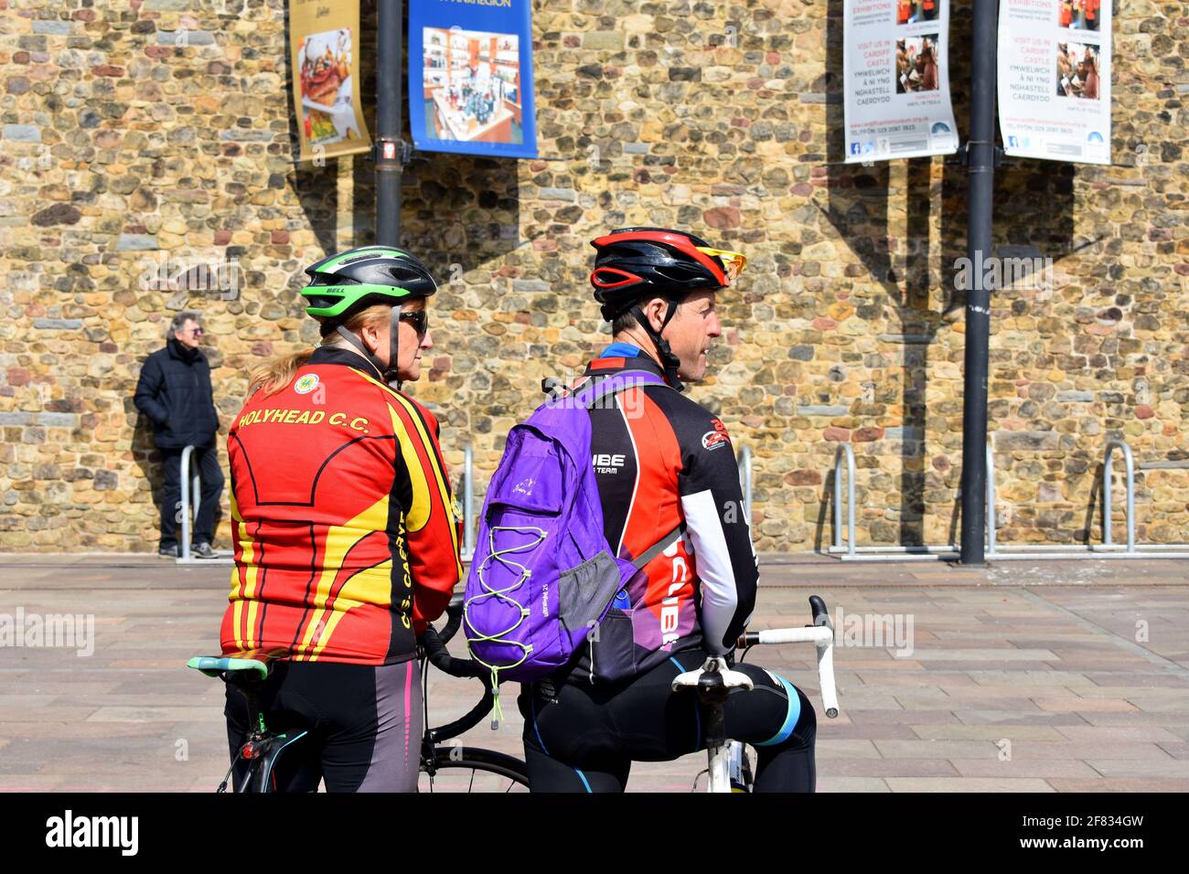 Pair of cyclists waiting outside Cardiff Castle for the 41 gun salute to mark Prince Philip's death, Cardiff, Wales Stock Photo