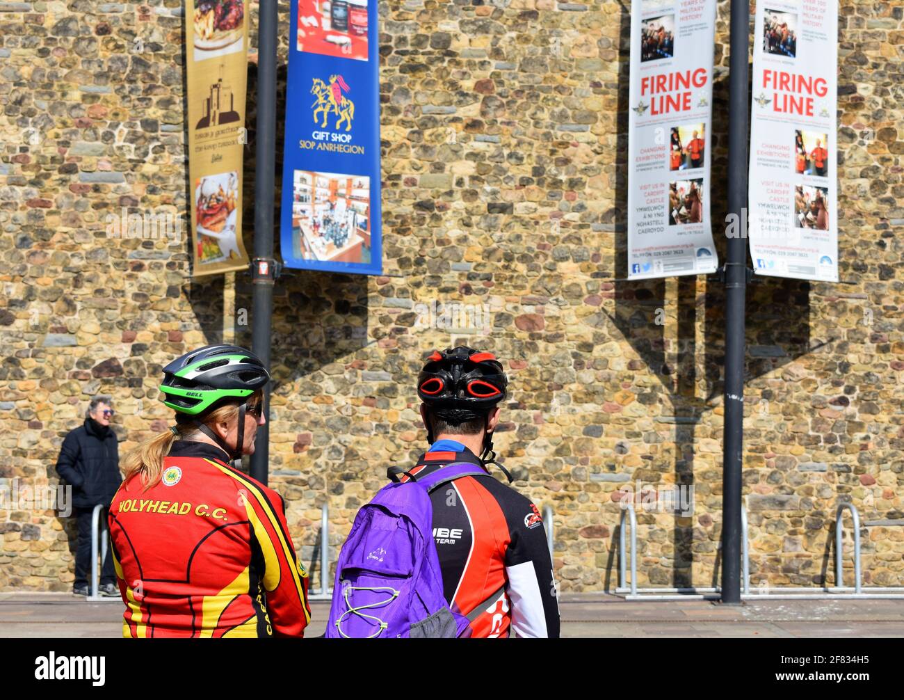 Pair of cyclists waiting outside Cardiff Castle for the 41 gun salute to mark Prince Philip's death, Cardiff, Wales Stock Photo