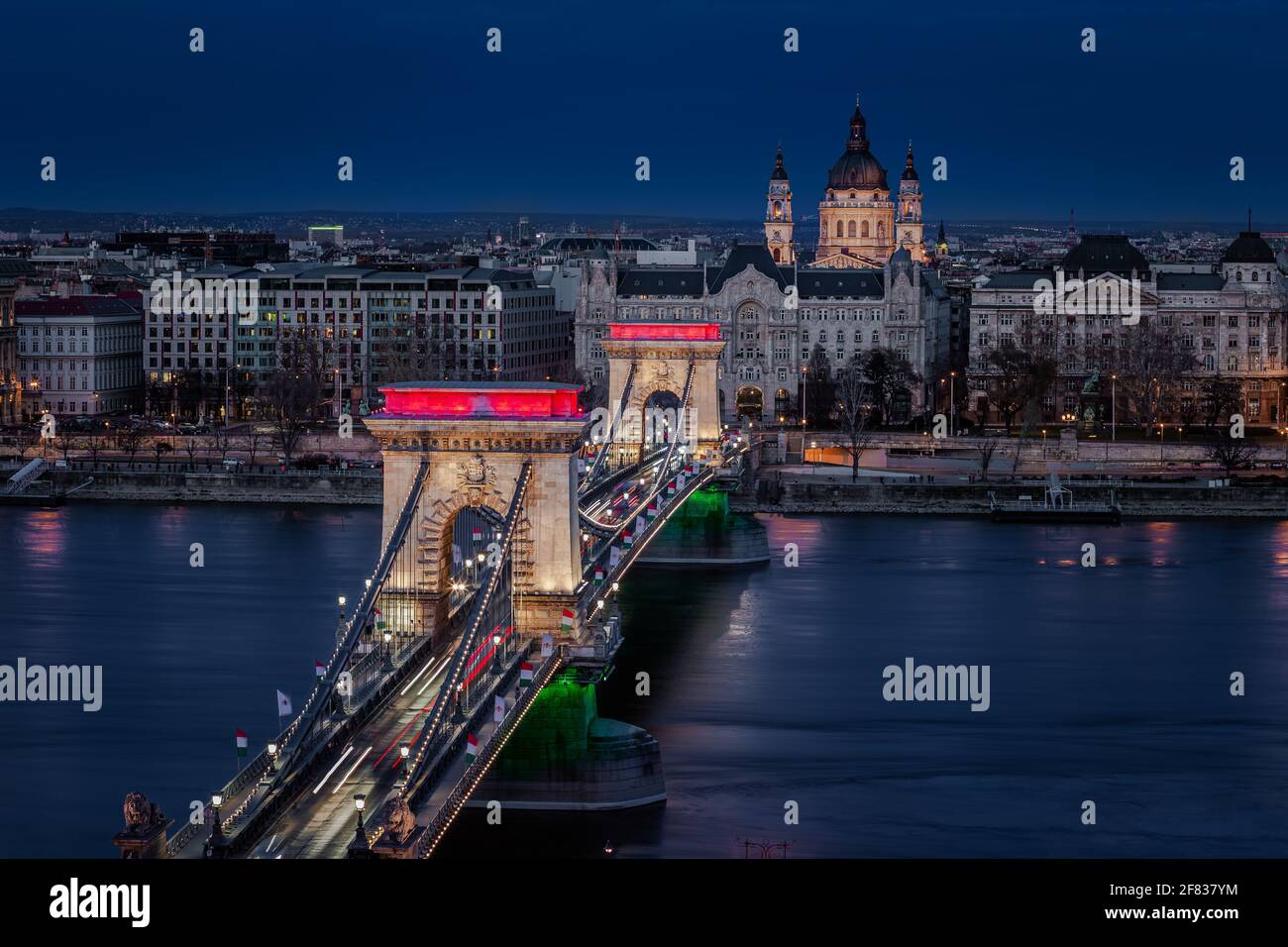 Budapest, Hungary - The world famous illuminated Szechenyi Chain Bridge (Lanchid) by night, lit up with national red, white and green colors, celebrat Stock Photo
