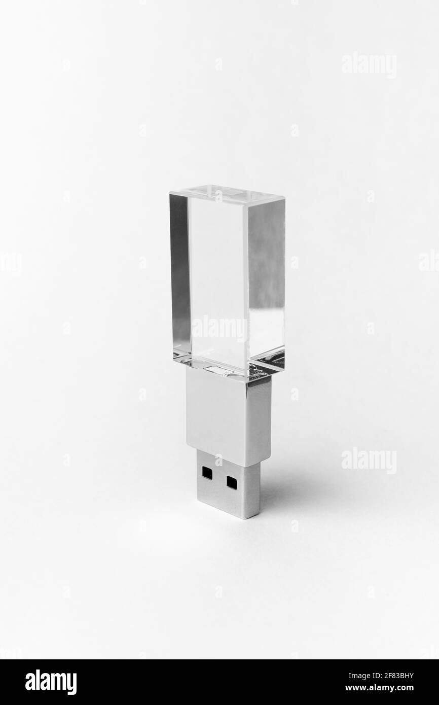 Glass transparent USB drive with metal insert isolated on grey background. Layout. Copy space. A high resolution. Stock Photo