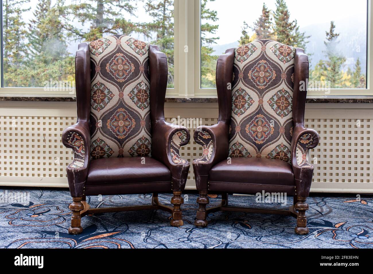 two tall chairs with pattern in front of a window Stock Photo - Alamy