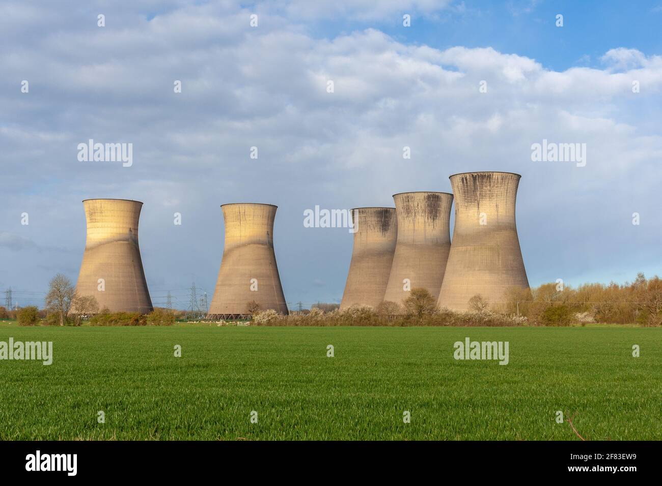 Willington, Derby, UK, April,11,2021:The large cooling towers of the now disused Willington Power Station. These tall iconic structures now standing d Stock Photo