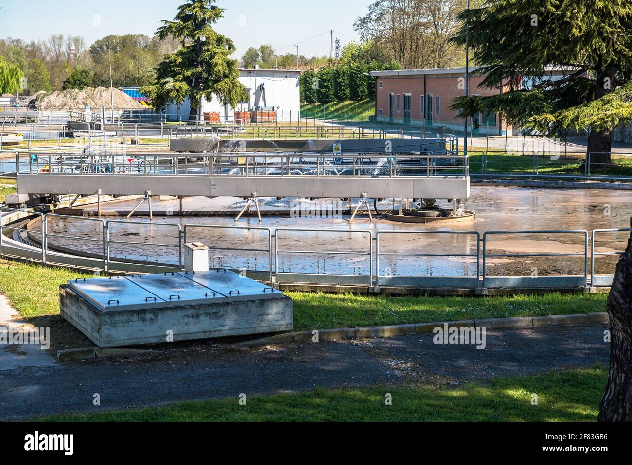 Round sedimentation tanks full of wastewater in a water treatment facility Stock Photo