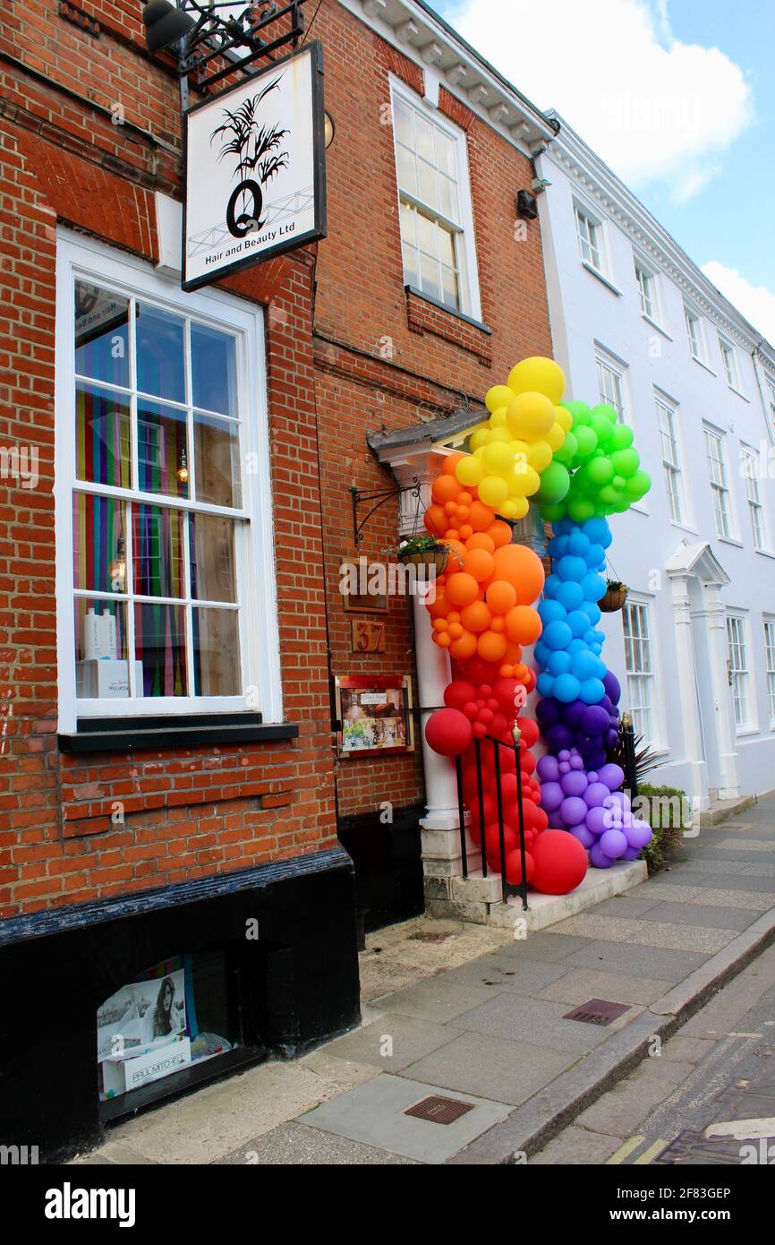 As lockdown restrictions end on May 12th 2021 a local business adorns its front door with colourful baloons to welcome back customers. Stock Photo