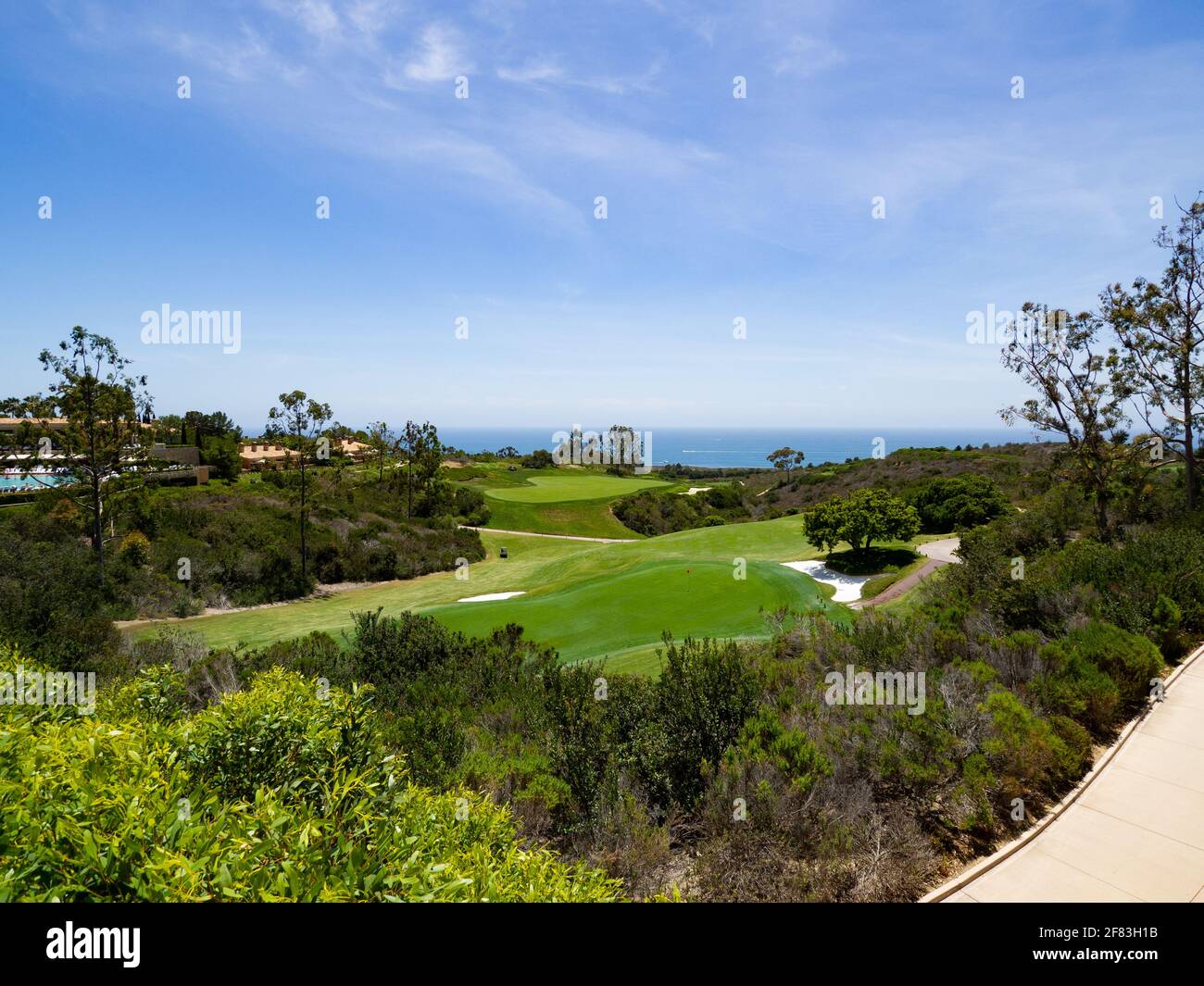 view of the ocean in the distance with a golf course in the foreground Stock Photo