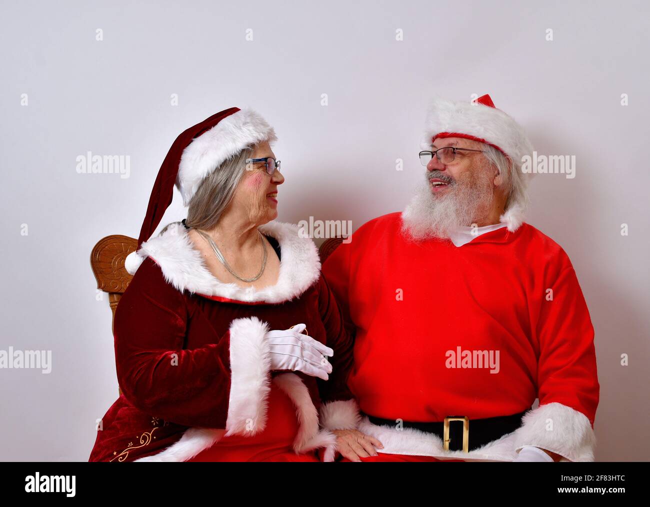 Lovely Mr and Mrs Santa Claus enjoying each other's company Stock Photo