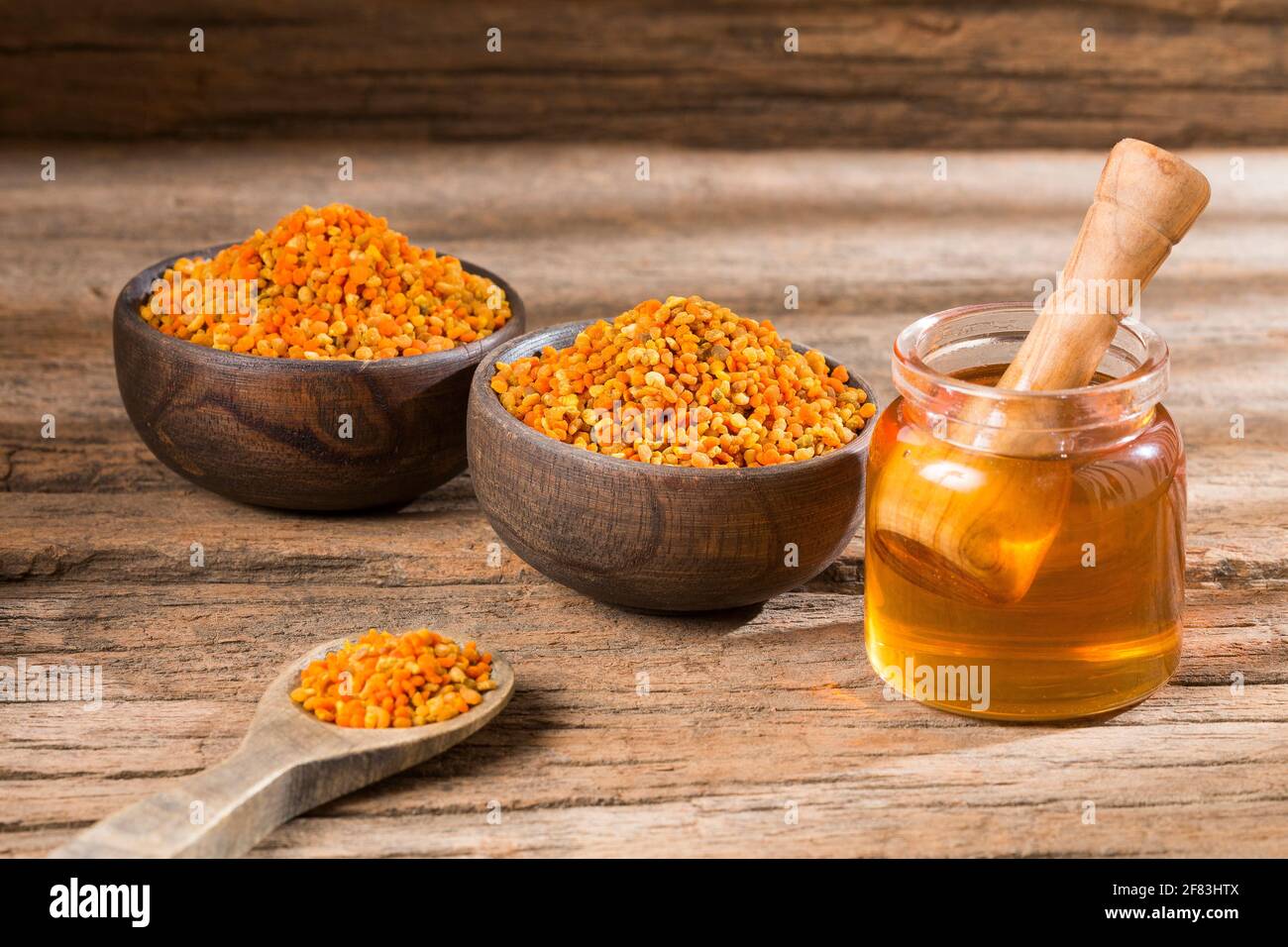 Bee honey and pollen grains. Natural sweetener Stock Photo - Alamy