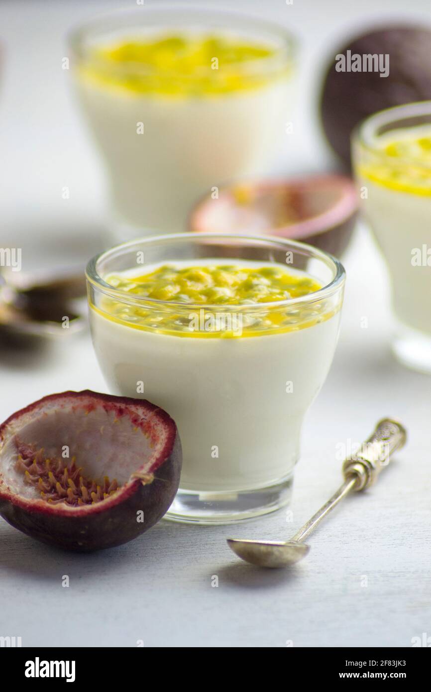 Italian dessert panna cotta with fresh passion fruits on light