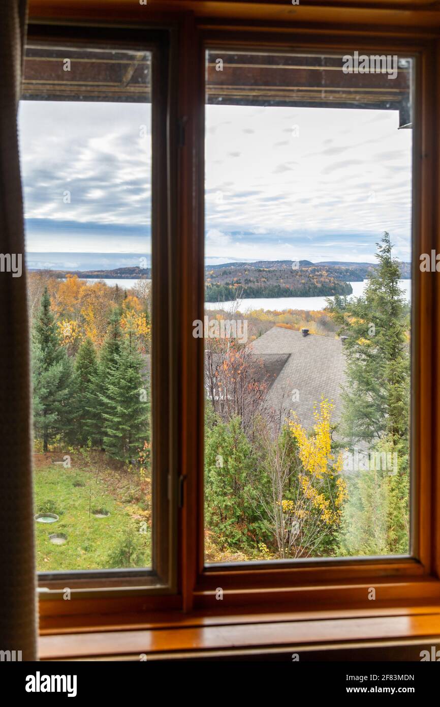 Window with a view of a valley with a forest and a lake in autumn Stock ...