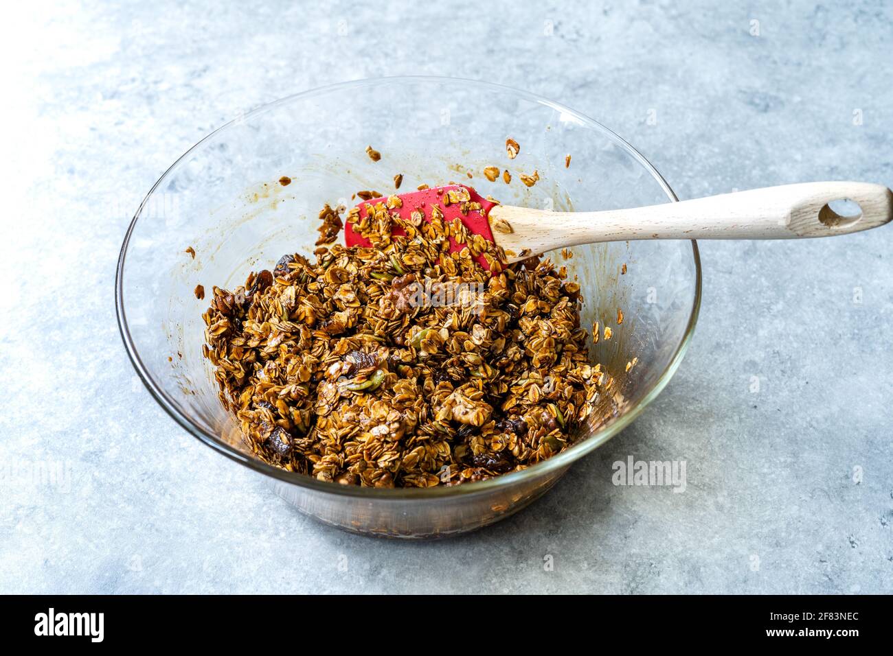 Homemade Baked Granola with Molasses Raisins and Nuts in Glass Bowl