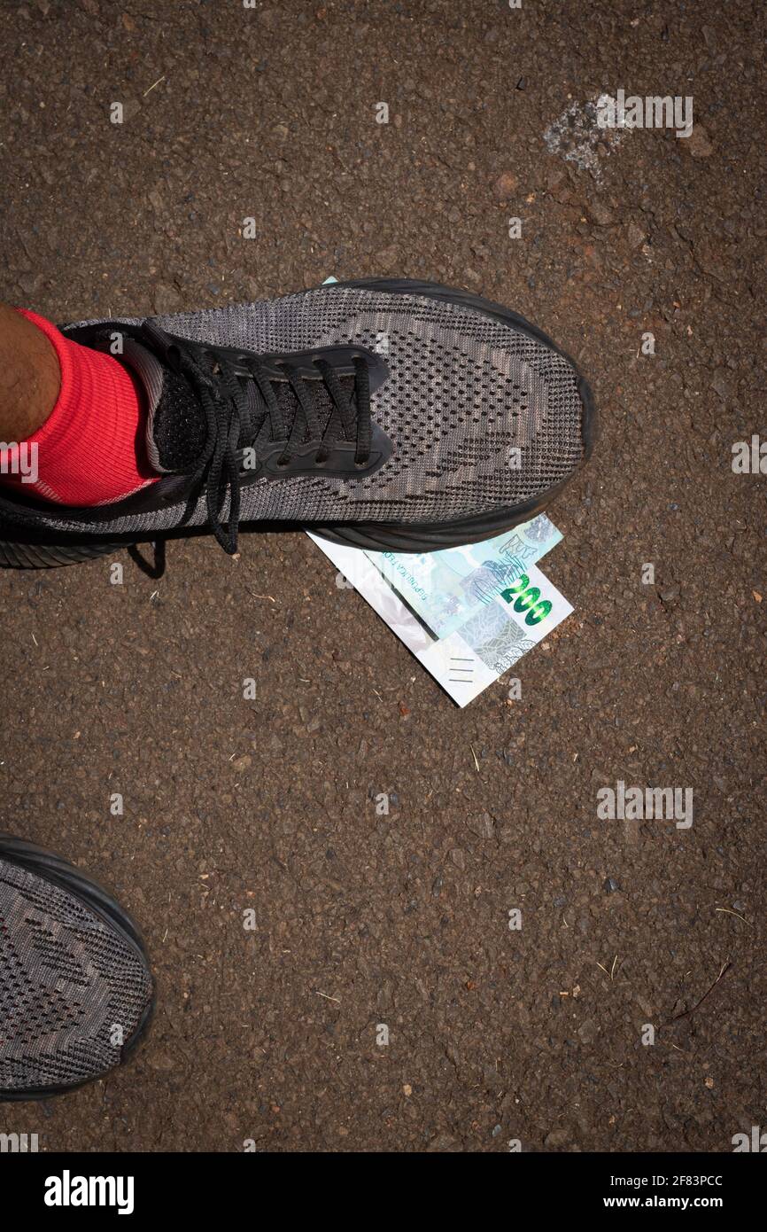 Stepping on Brazilian money. Concept image of Brazilian economy. Stock Photo