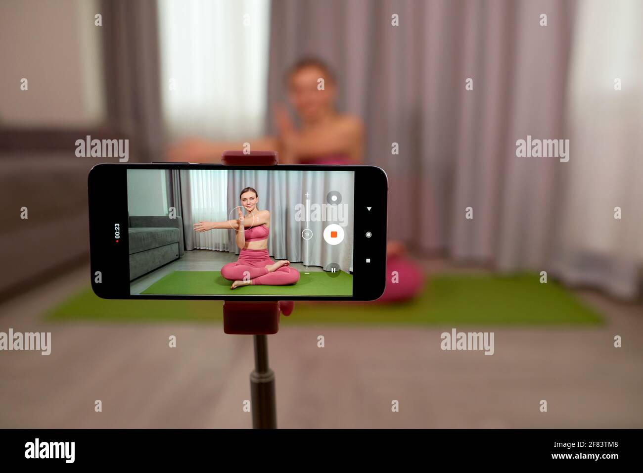 phone screen with online training yoga at home and blured woman fit trainer  on background. Sport, fitness, health care and lifestyle Stock Photo - Alamy