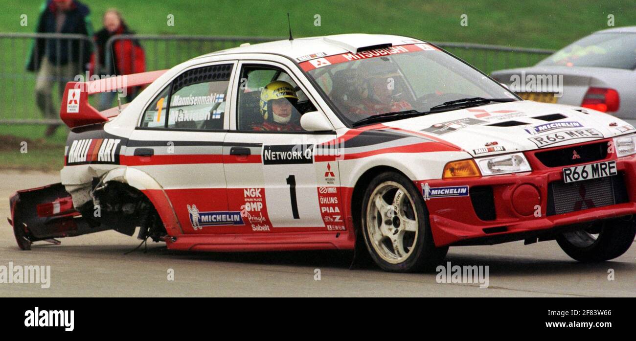 Tommi Makinen Rallying Network Q Rally 1998 TOMMI MAKINEN IN A MITSUBISHI  LANCER EVO AFTER THE 1ST MILLBROOK STAGE GOING TO THE START OF THE  2ND.Makinene Lost his rear wheel after colliding