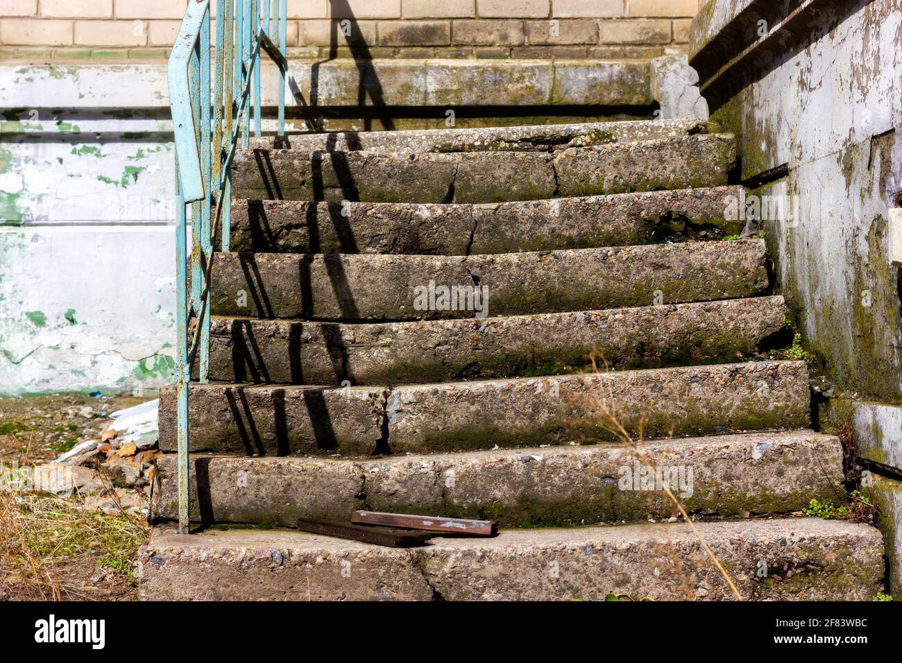 Old broken staircase. Broken concrete steps in an abandoned house Stock