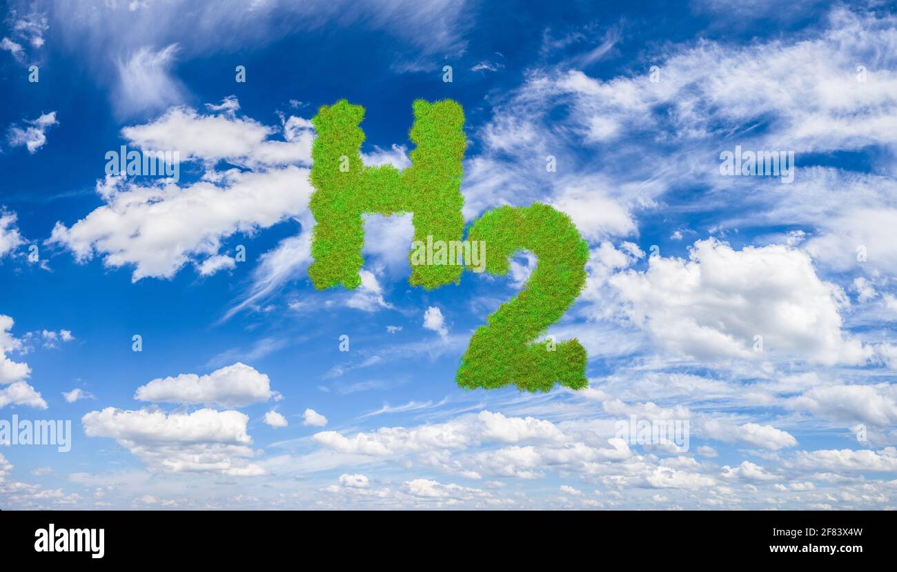 Green Hydrogen concept: The letters H2 as green grass on blue sky with clouds. Stock Photo