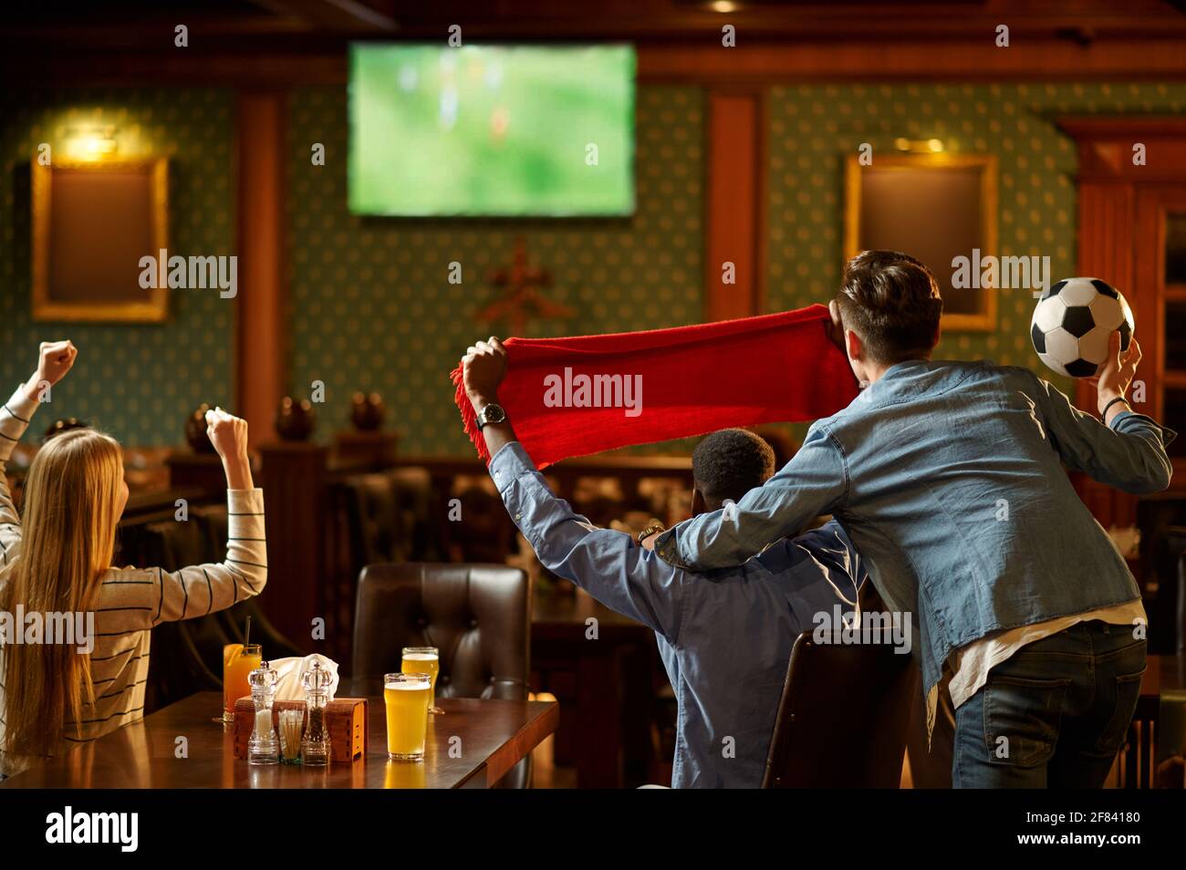 Football fans watching game translation in bar Stock Photo Alamy