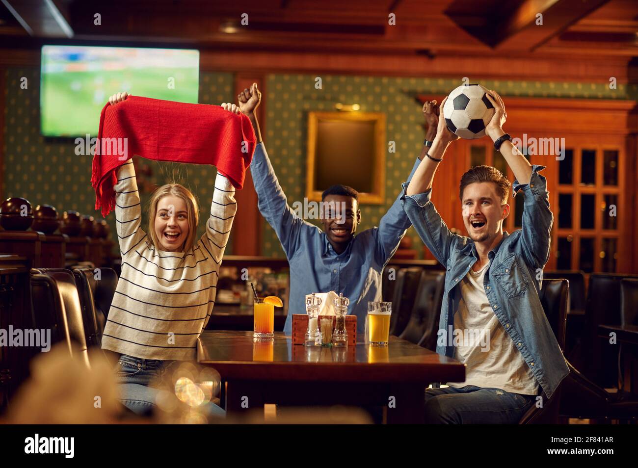Football fans watching game translation in bar Stock Photo Alamy