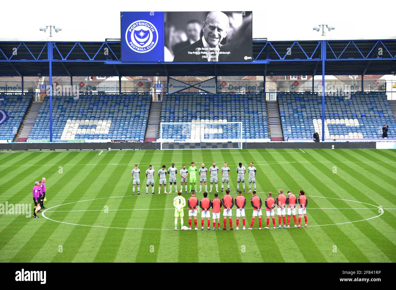 The players and officials during the 2 minutes silence to mark the death of Prince Philip before the Sky Bet League One match between Portsmouth and Burton Albion at Fratton Park  , Portsmouth ,  UK - 10 April 2021 - Editorial use only. No merchandising. For Football images FA and Premier League restrictions apply inc. no internet/mobile usage without FAPL license - for details contact Football Dataco Stock Photo