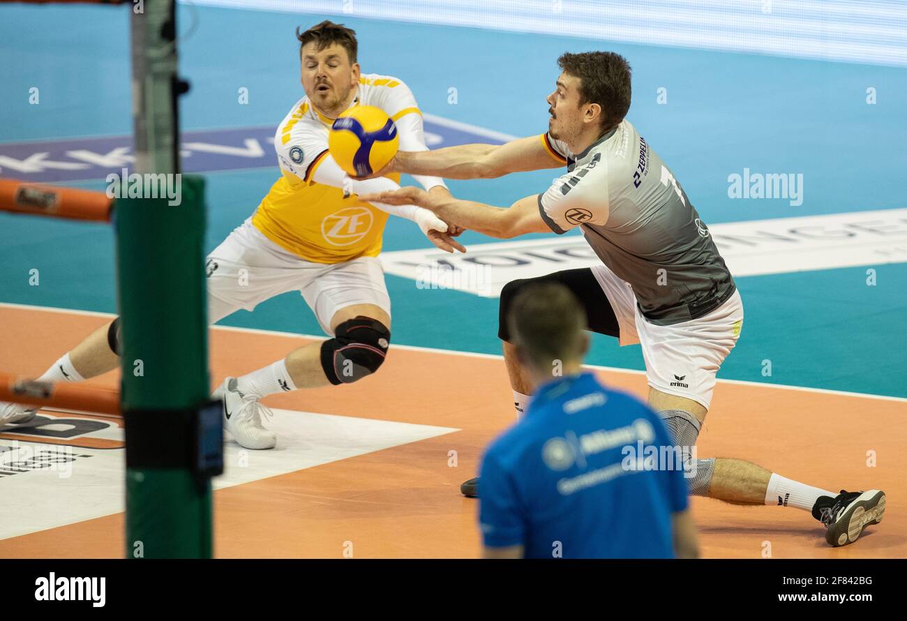 Berlin, Germany. 11th Apr, 2021. Volleyball, Men: Bundesliga, Berlin Volleys - VfB Friedrichshafen, Championship round, Final, Matchday 2, Max-Schmeling-Halle. Libero Markus Steuerwald (l) and Rares Balean of VfB Friedrichshafen take the ball from below. Credit: Andreas Gora/dpa/Alamy Live News Stock Photo