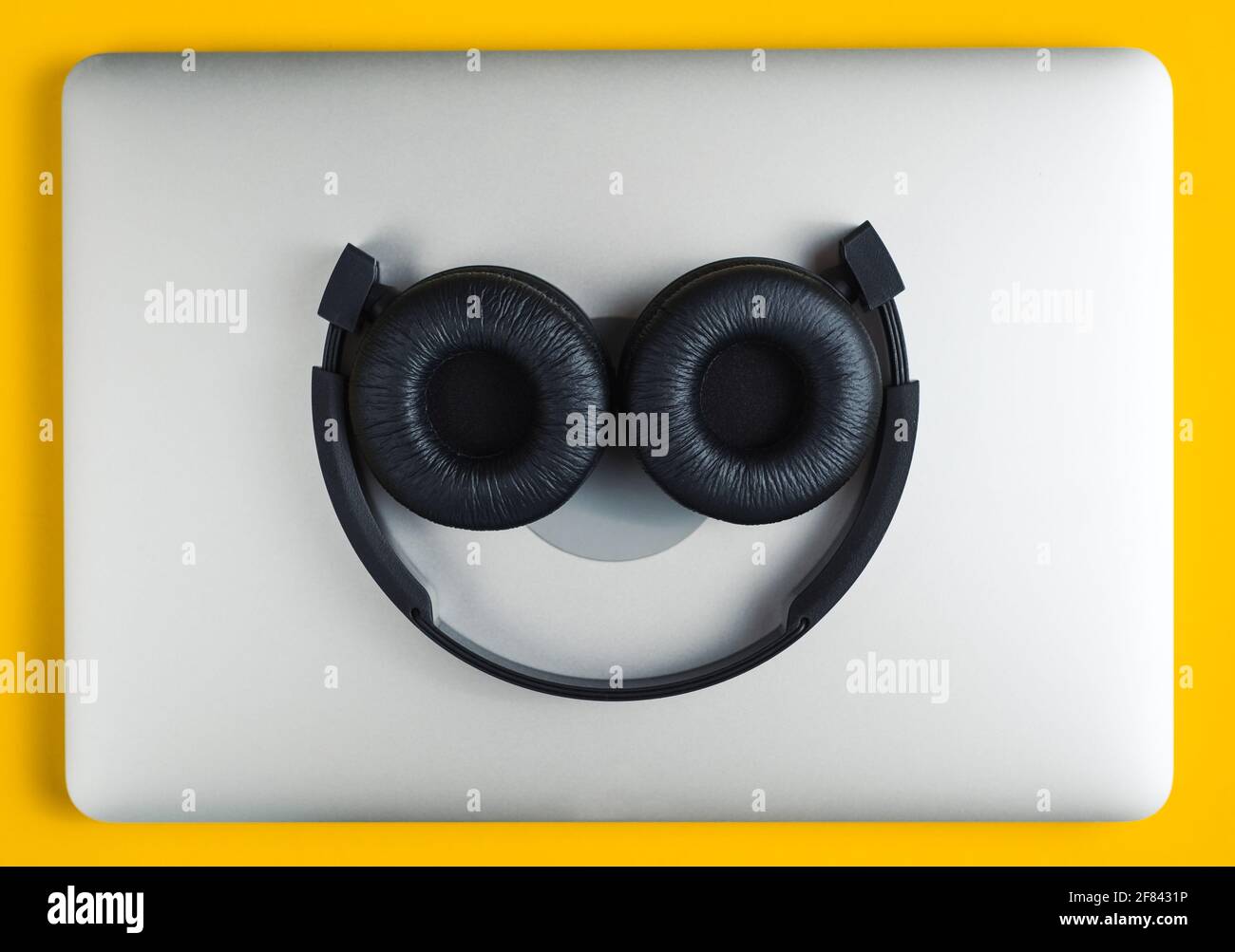 Headphones lie on notebook. Stock Photo