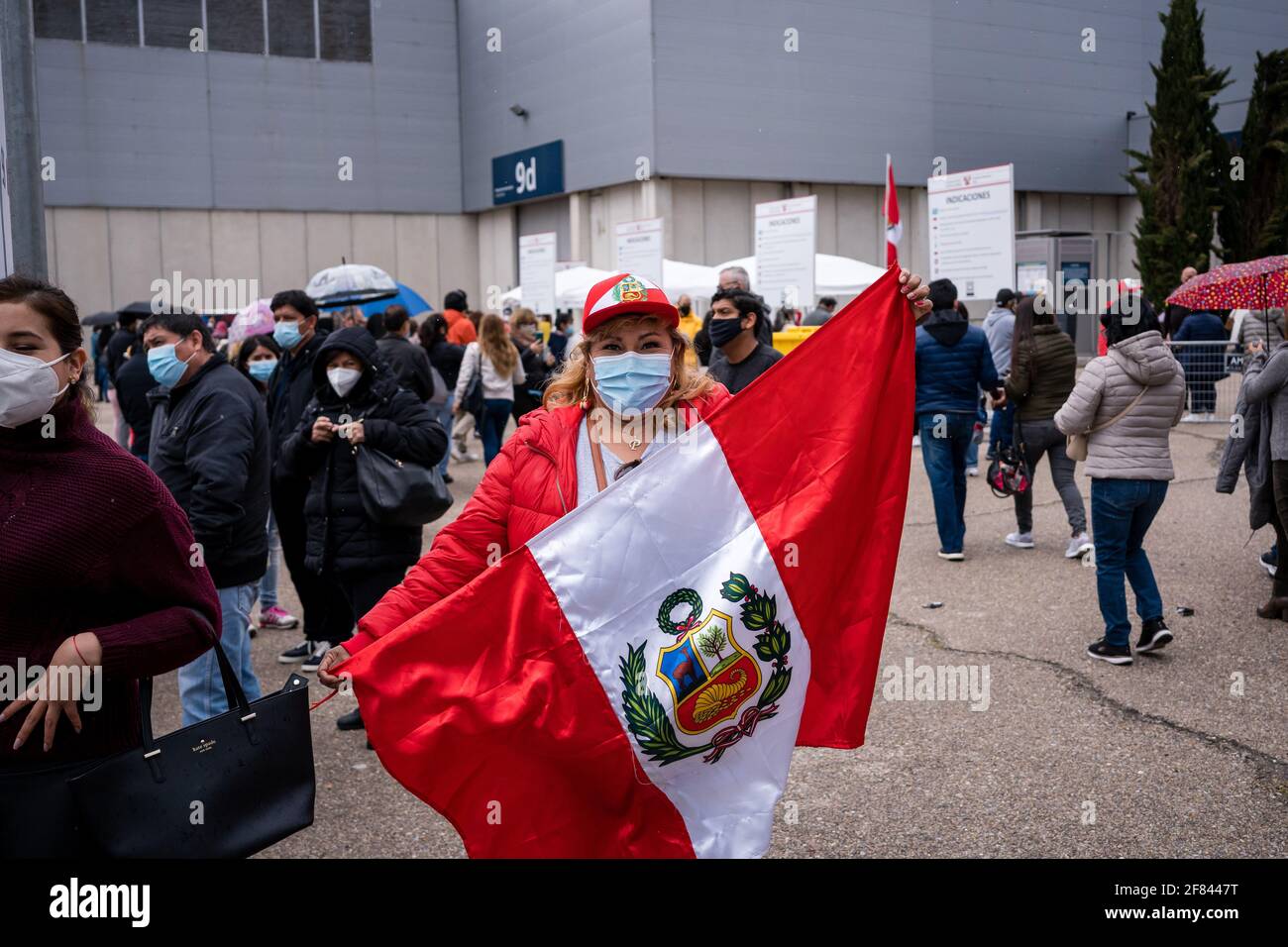 A woman poses with the Peruvian flag at IFEMA during the Peruvian elections  in Madrid.Peru and Ecuador are two of the largest migrant populations in  Spain. Today the general elections in Peru